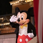 A person dressed in a mickey mouse costume
