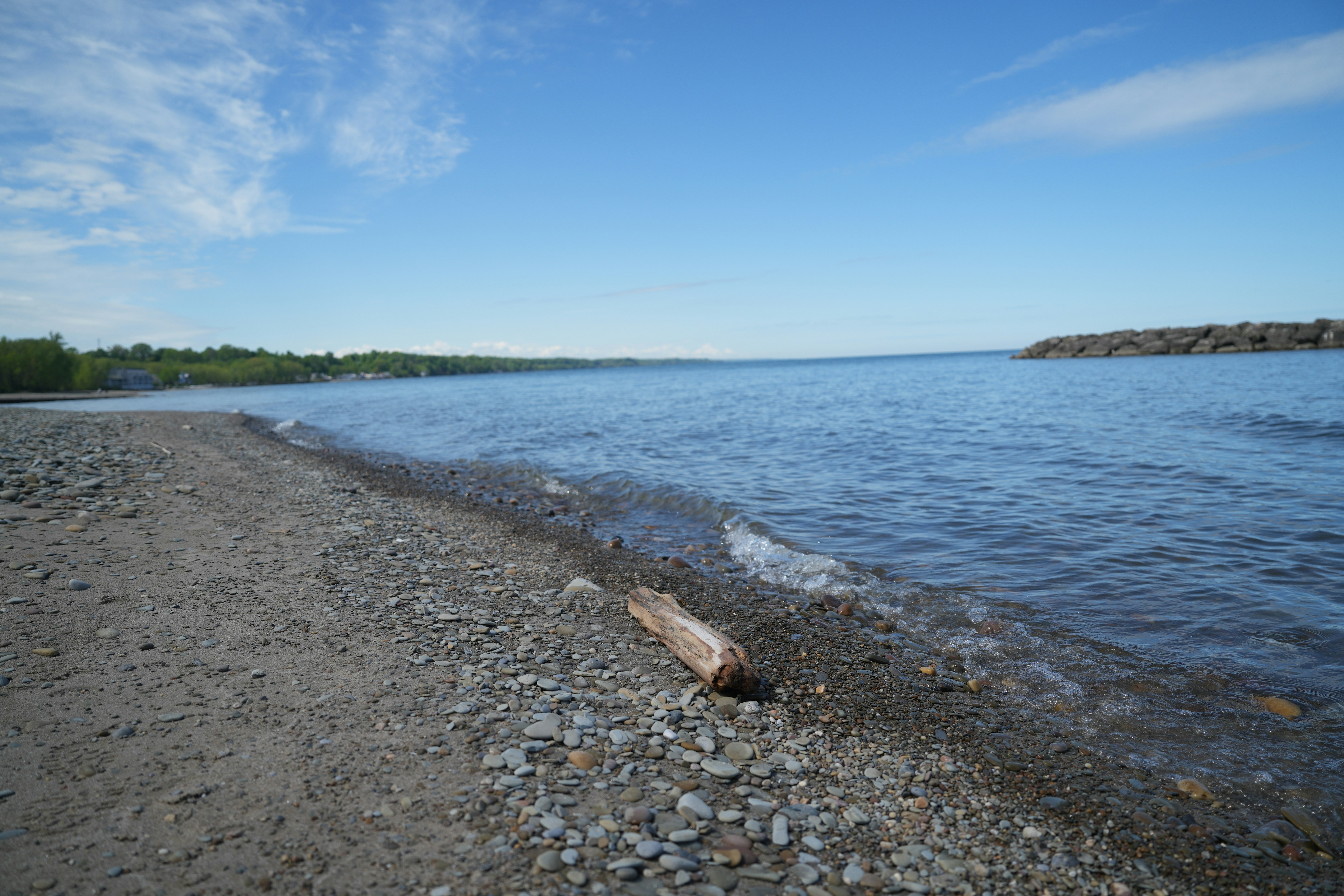 A body of water sitting next to a sandy beach