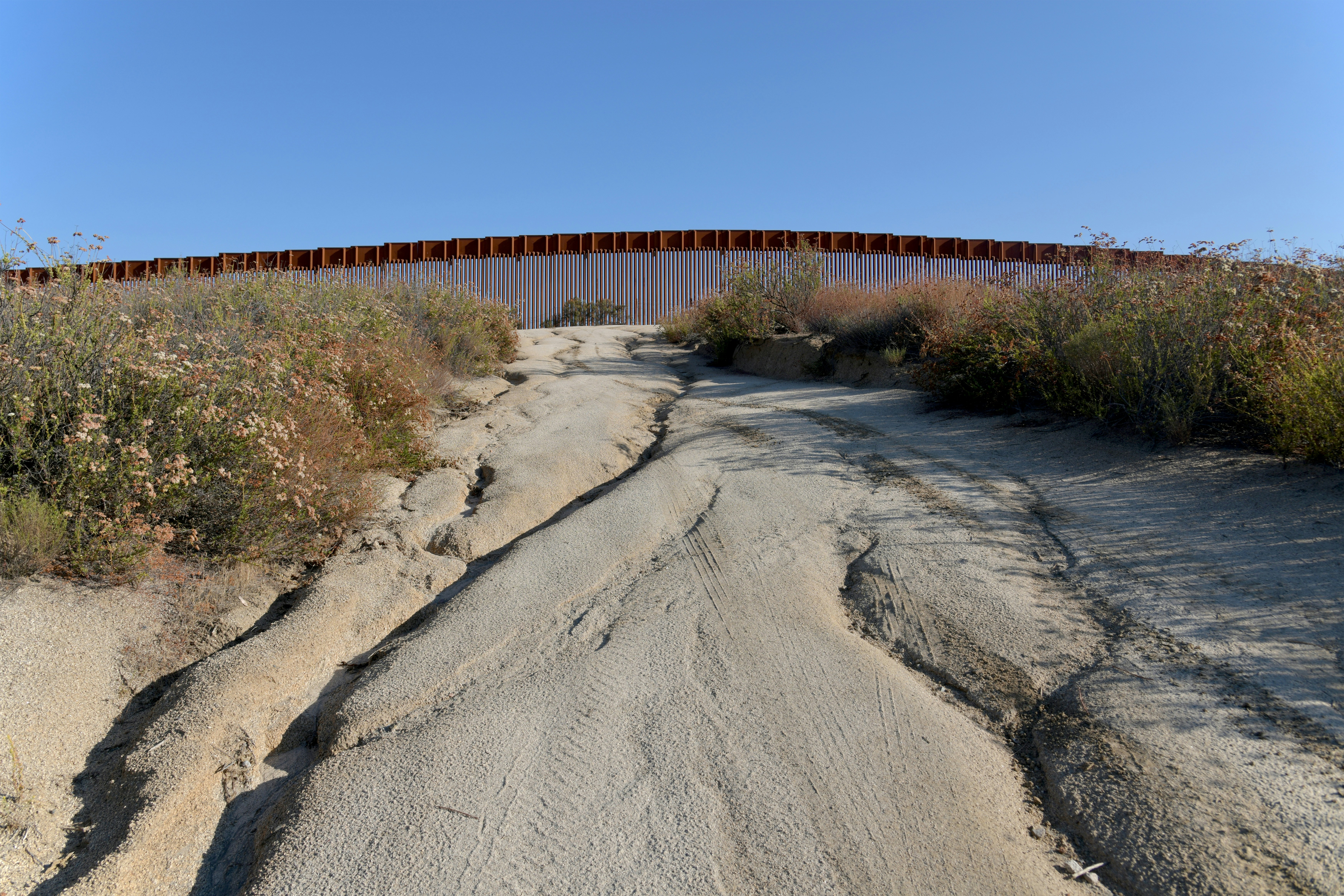 Ein Feldweg mit einem Zaun im Hintergrund