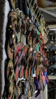 A bunch of shoes are hanging on a wall