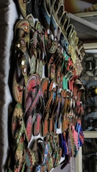 A bunch of shoes are hanging on a wall