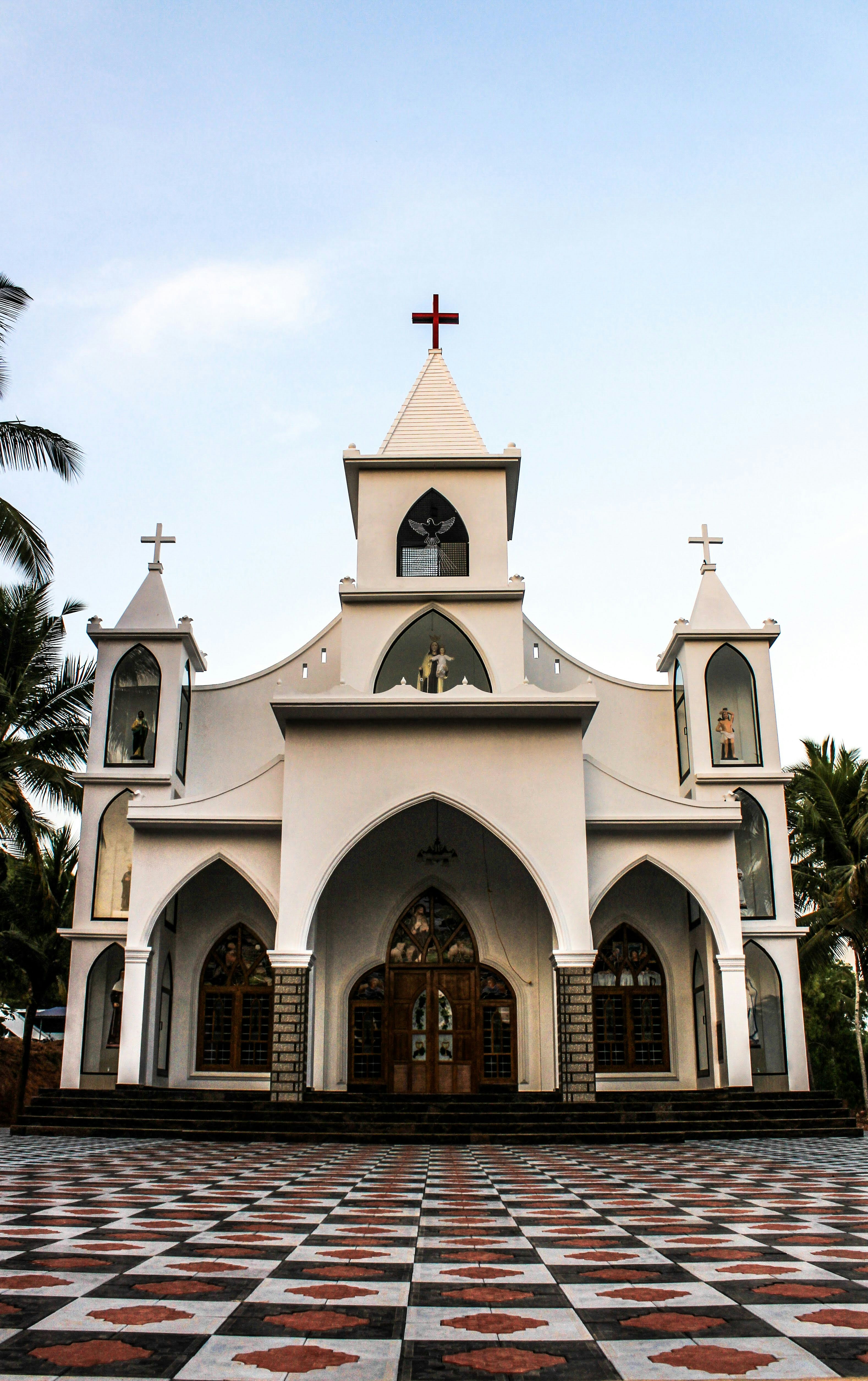 A white church with a black and red checkered floor