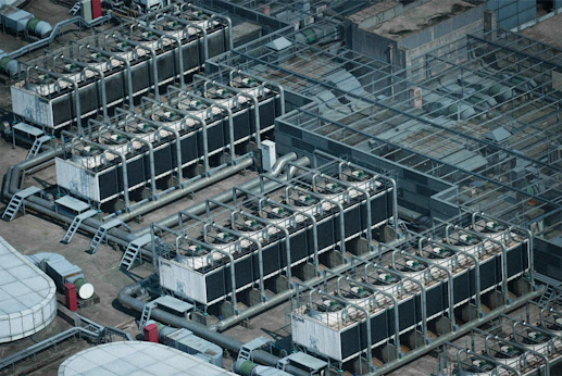 An aerial view of a factory with many tanks