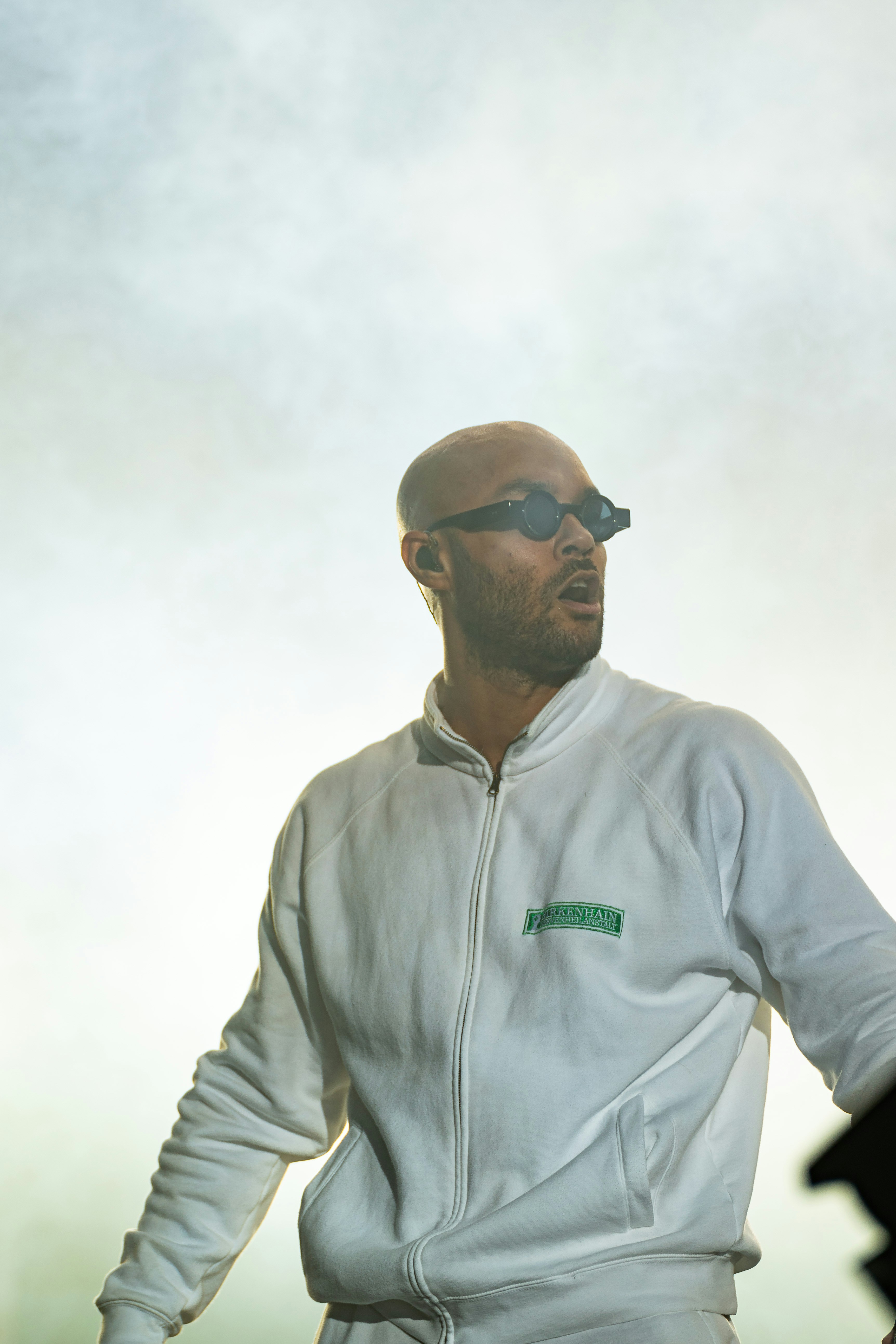 A man wearing a white suit and sunglasses