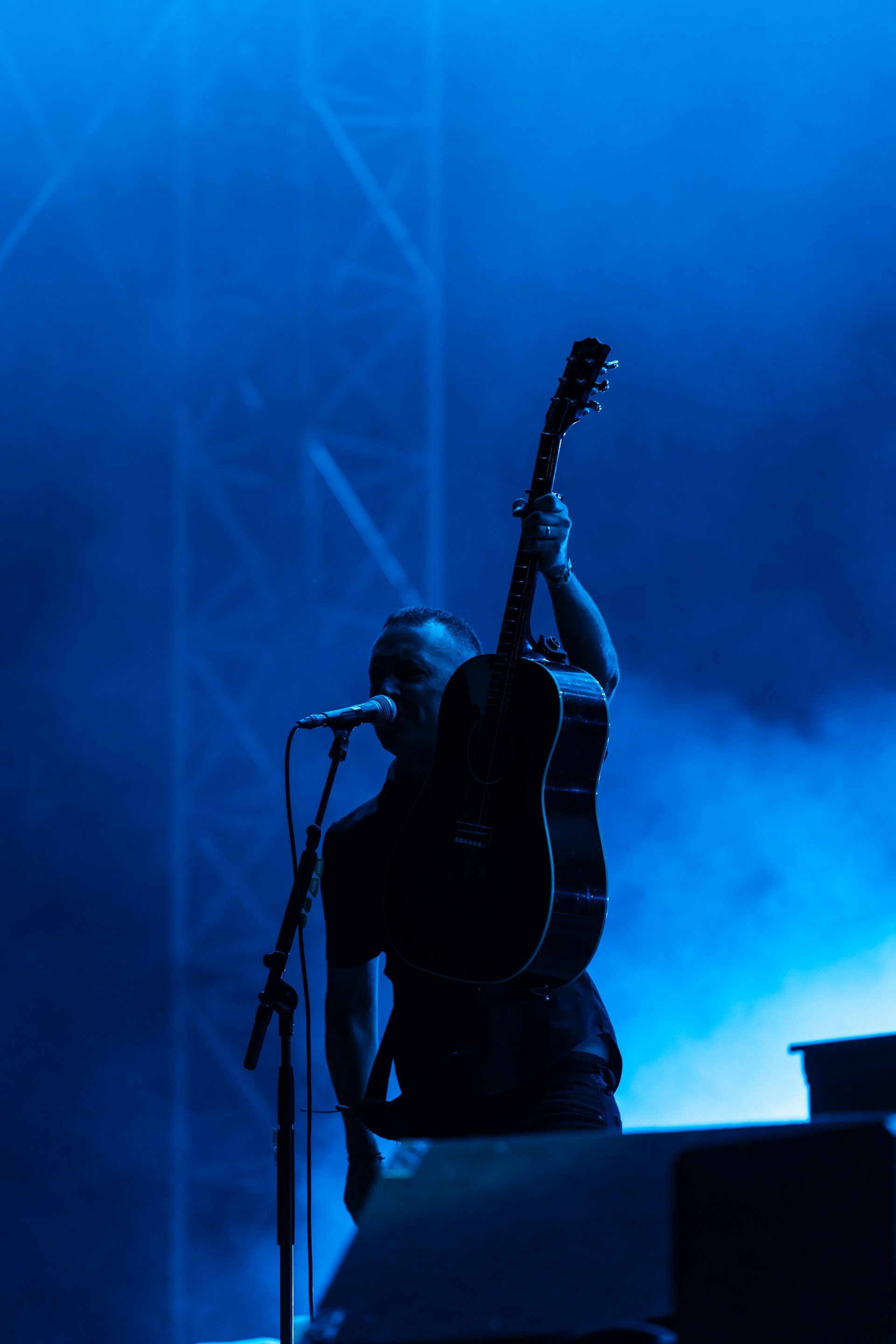 A man playing a guitar on a stage