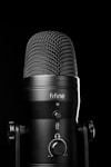 A black microphone with a black background