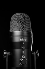 A black microphone with a black background