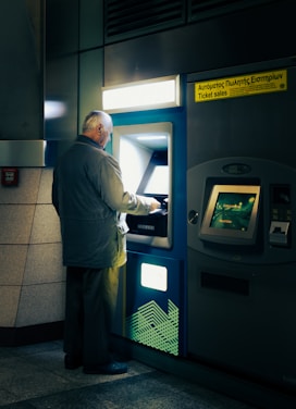 A man standing in front of a atm machine