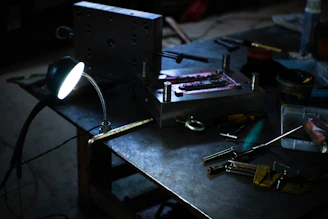 A table topped with lots of tools and a light