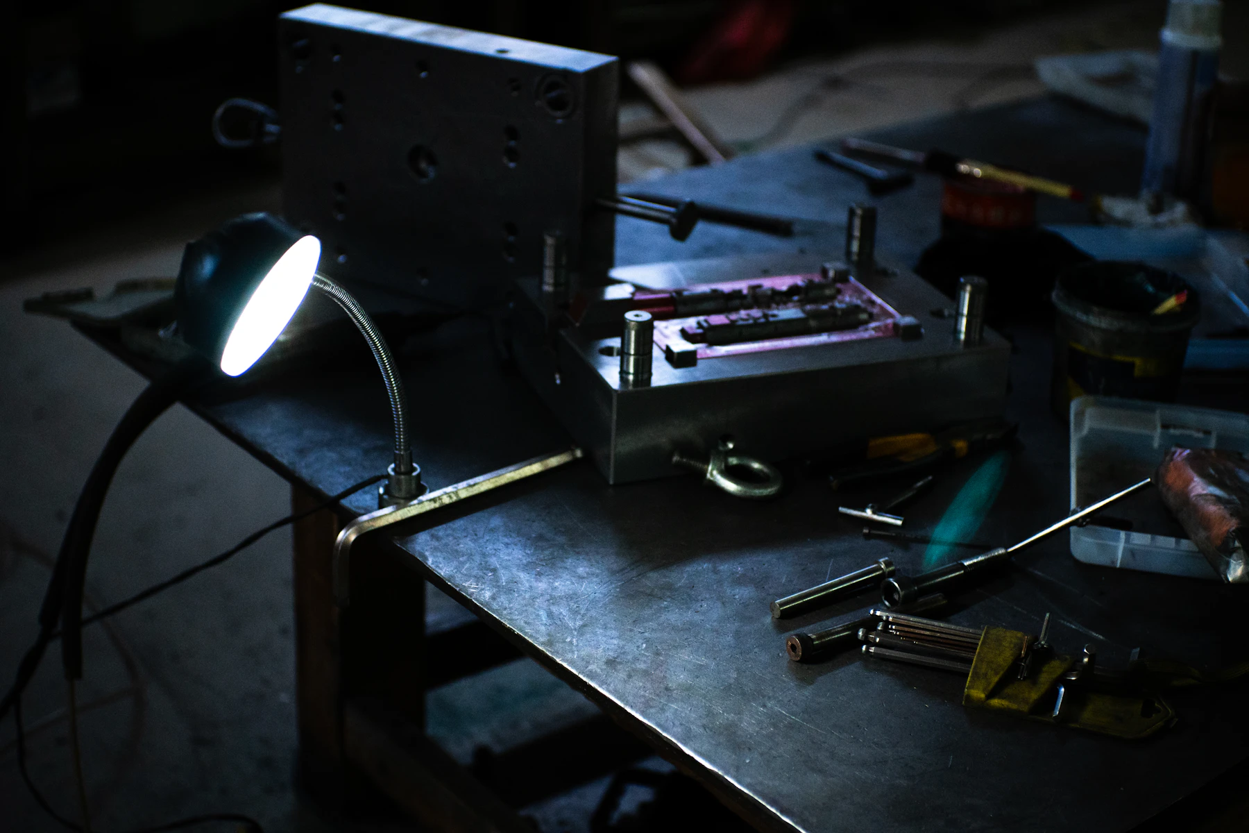Long-form composition showing a collaborative tabletop with design, engineering, and field tools