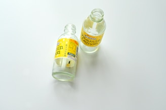 A bottle of mouthwash sitting next to a bottle of mouthwash