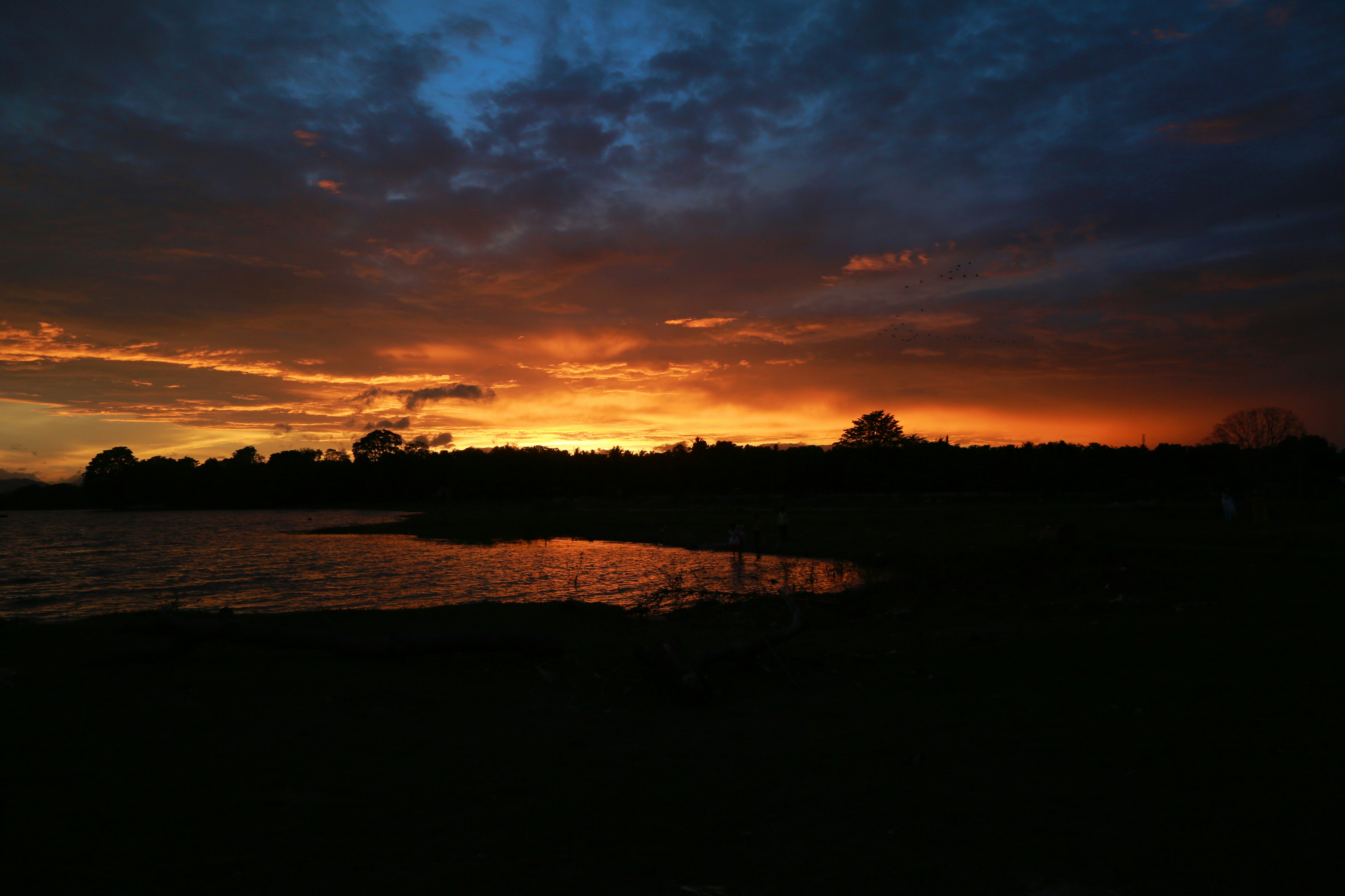 The sun is setting over a body of water