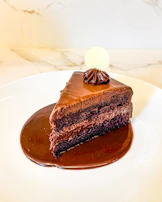 A piece of chocolate cake on a white plate