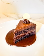 A piece of chocolate cake on a white plate