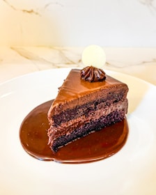 A piece of chocolate cake on a white plate