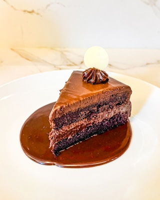 A piece of chocolate cake on a white plate