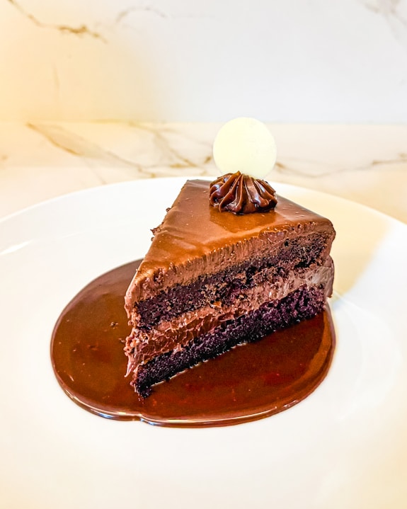 A piece of chocolate cake on a white plate