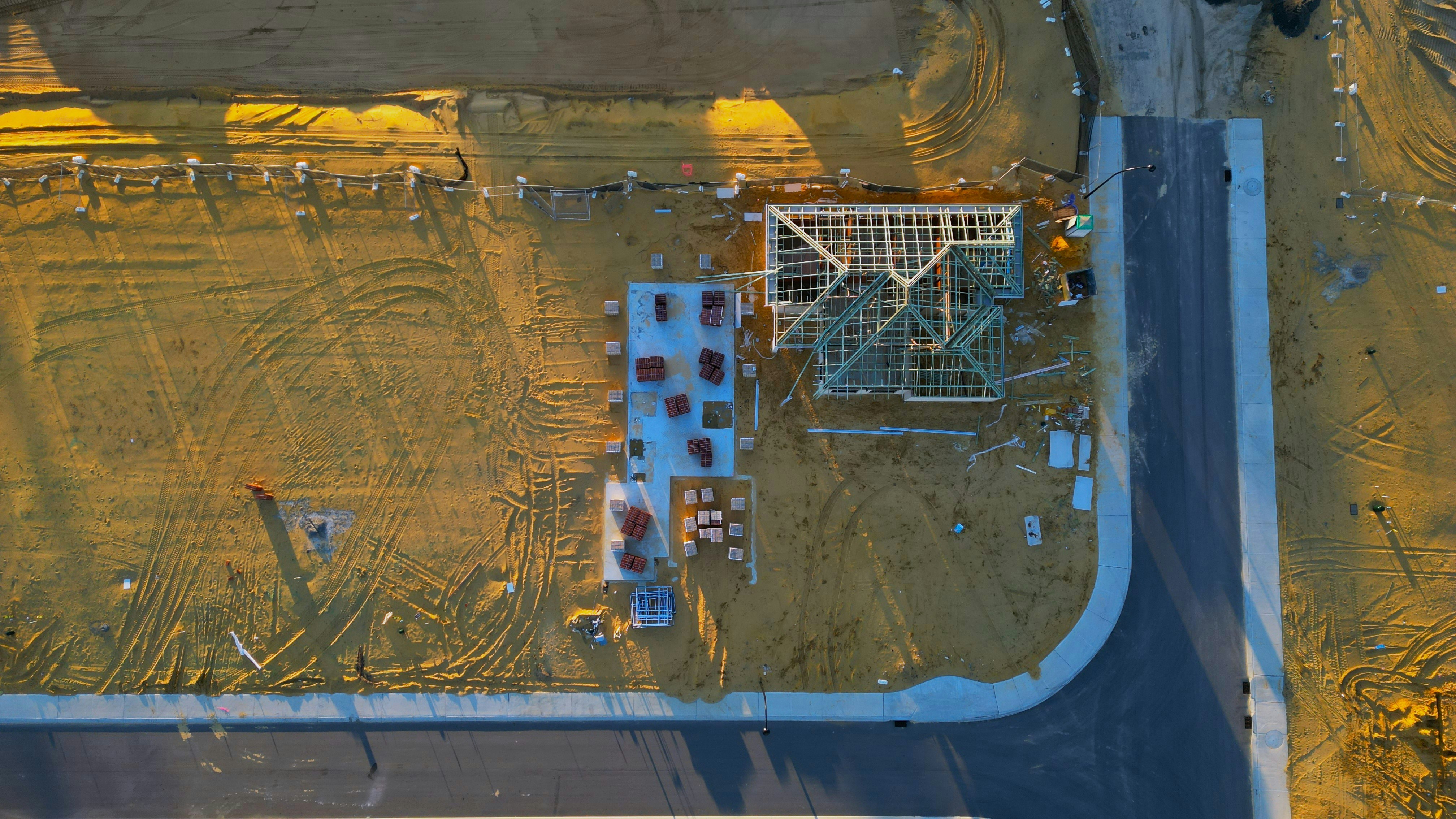 An aerial view of a construction site in the middle of a field