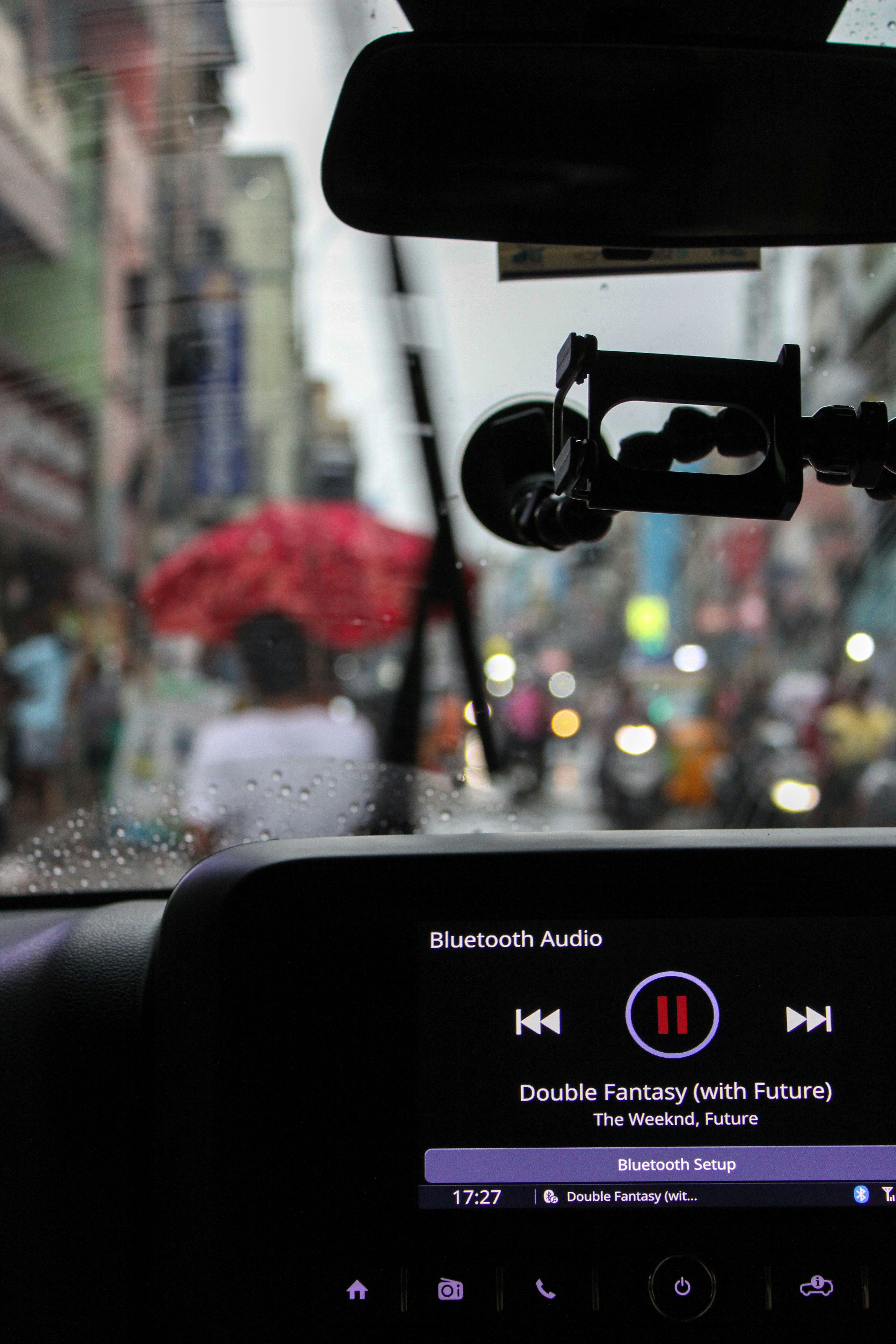 The dashboard of a car with a view of a busy street