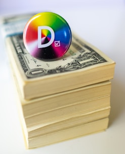 A button sitting on top of a stack of money
