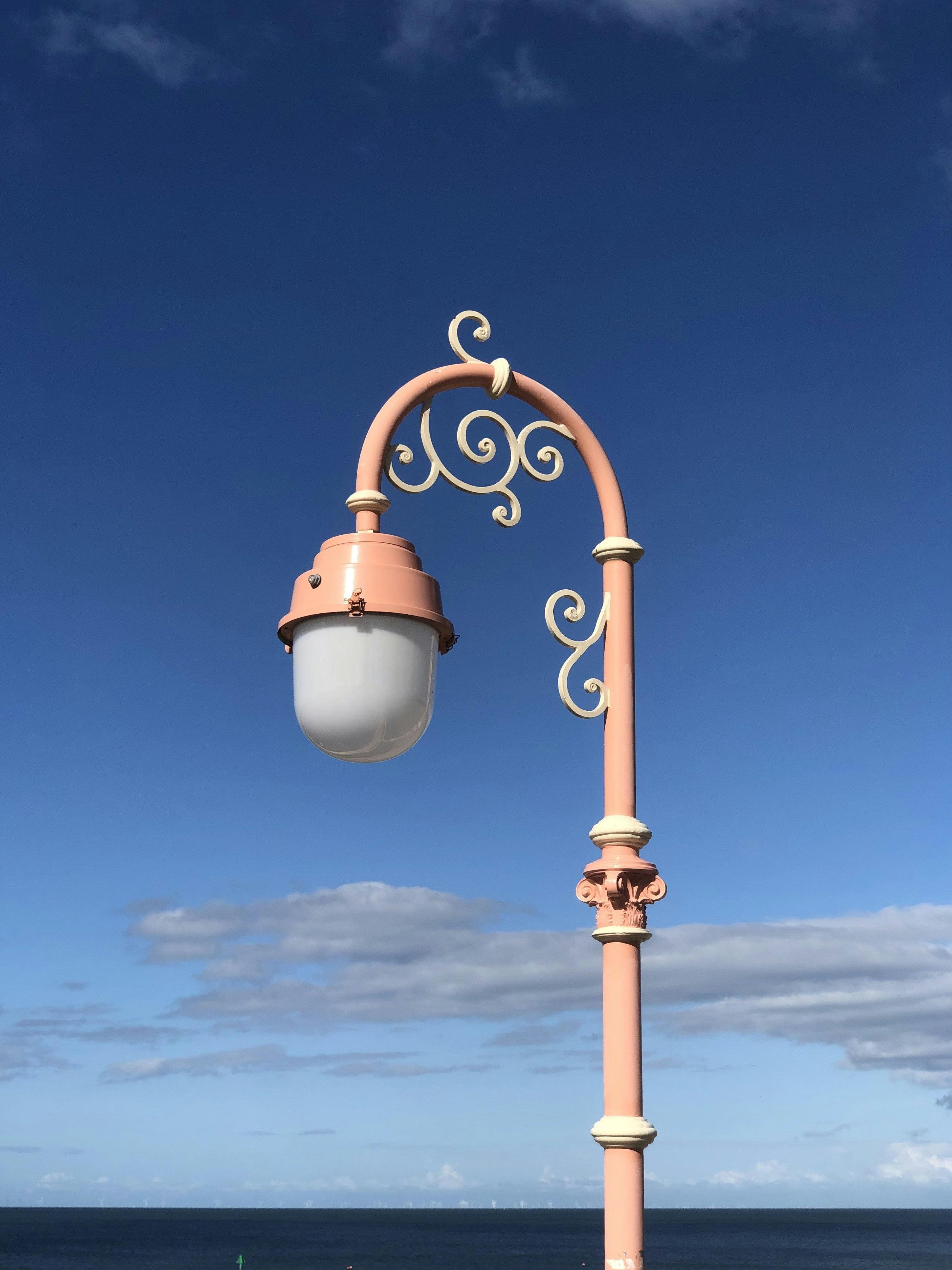 Una farola en un poste junto al océano