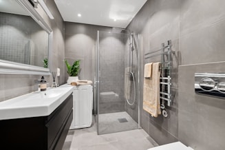 A bathroom with a toilet, sink, and shower
