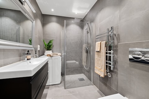 A bathroom with a toilet, sink, and shower