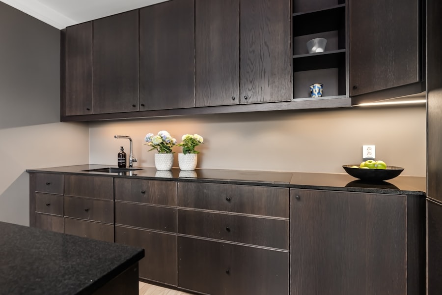 Dark wood kitchen with black countertops