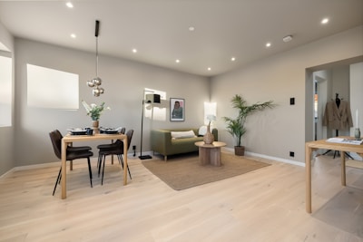 A living room filled with furniture and a dining room table