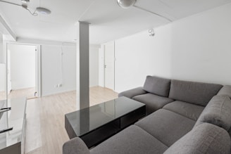 A living room filled with furniture and a glass table