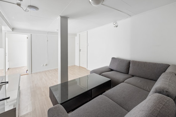 A living room filled with furniture and a glass table