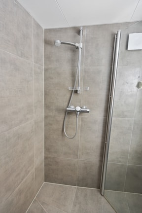 A walk in shower sitting next to a toilet