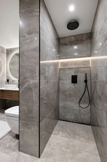 A bathroom with a toilet and a shower