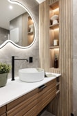 A bathroom with a sink and a large mirror