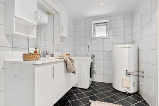 A bathroom with a washer and dryer in it