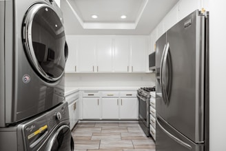 A washer and dryer are in a kitchen