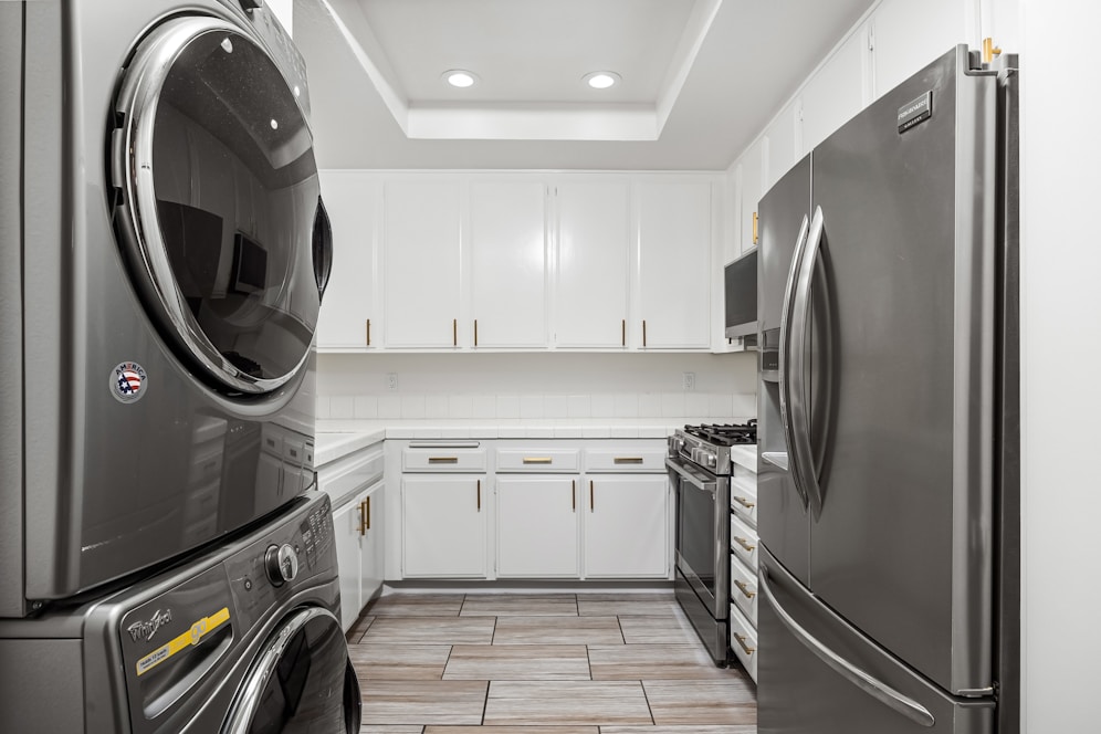 A washer and dryer are in a kitchen