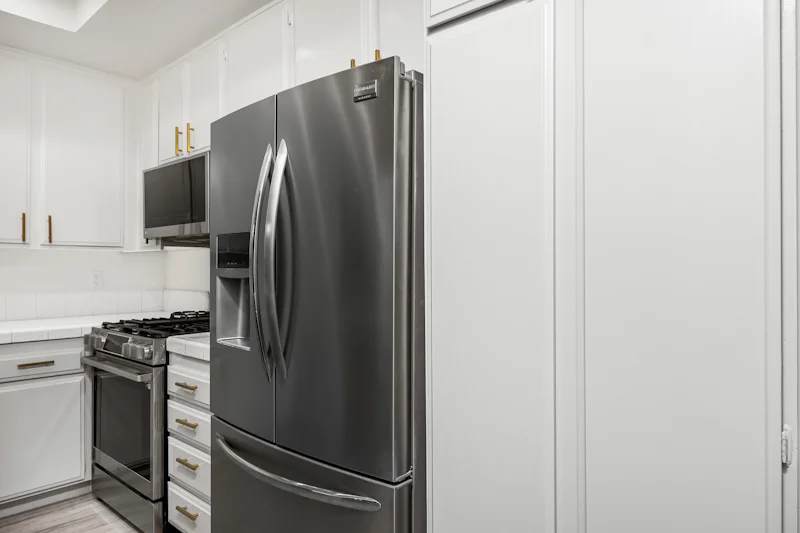 Kitchen with white cabinets and stainless steel appliances
