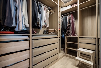 A walk in closet filled with lots of clothes