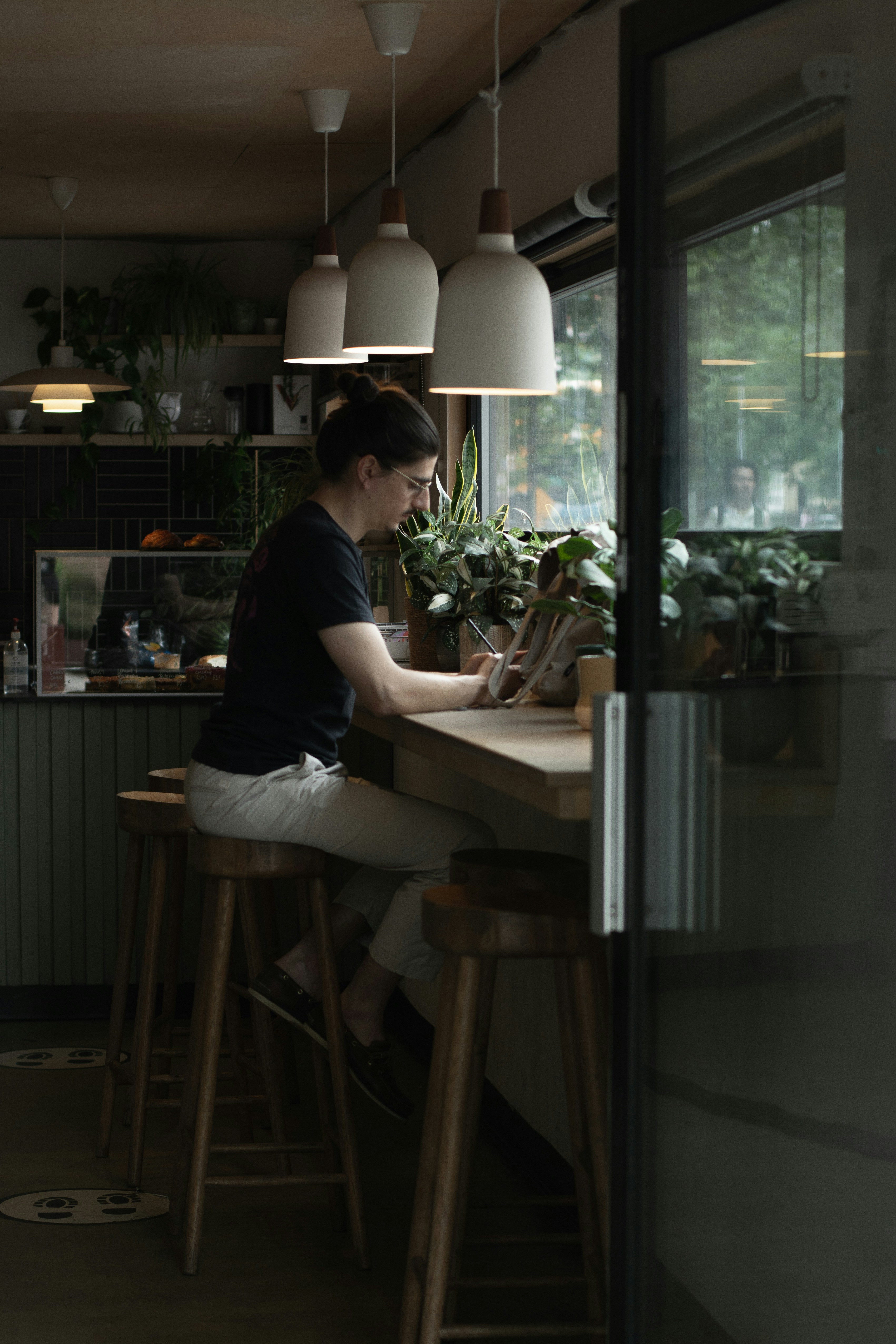 A woman sitting at a counter working on a laptop