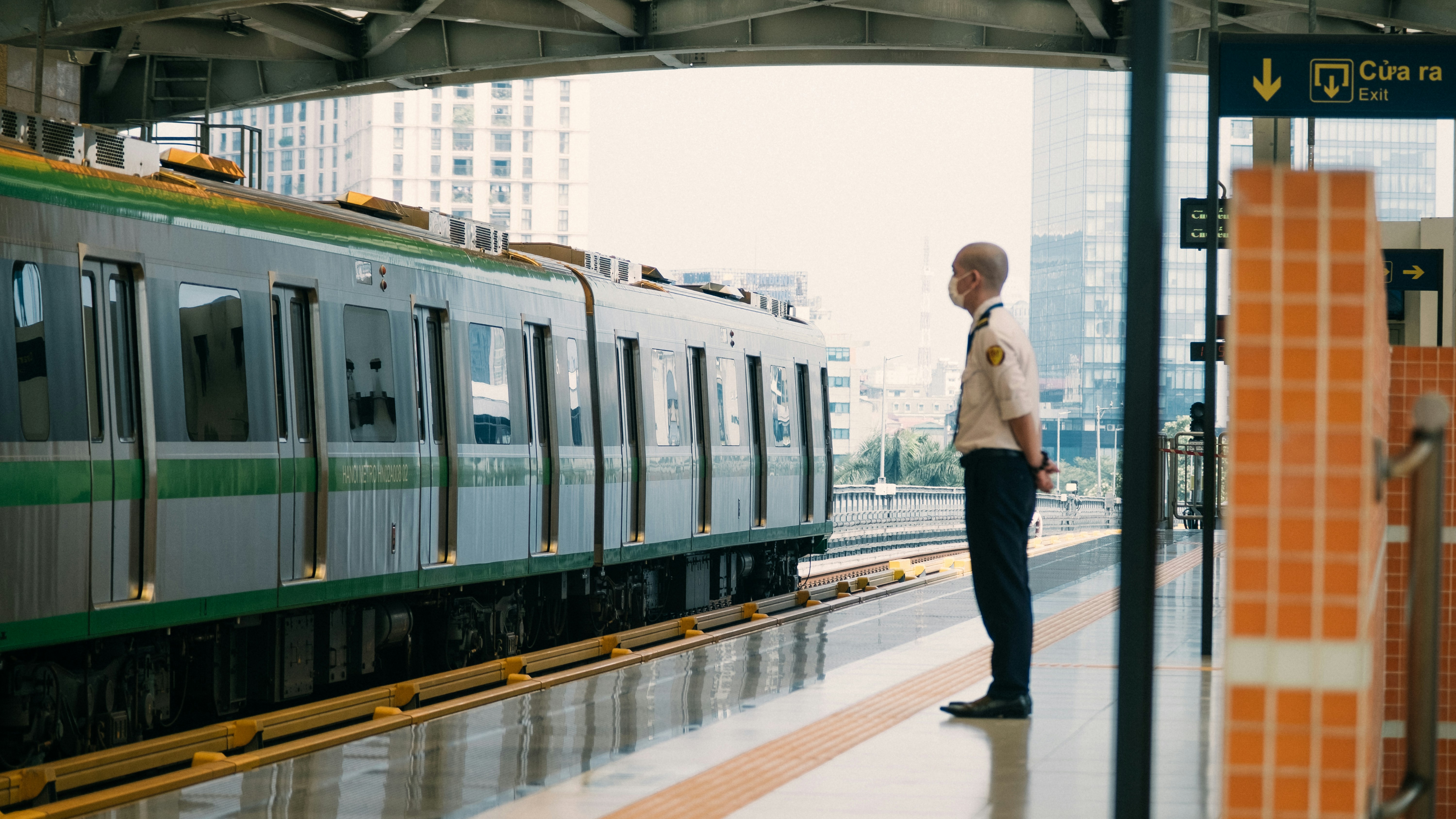 A man standing on a platform next to a train