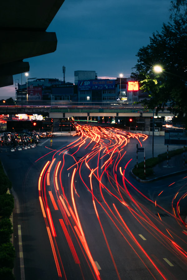 Traffic light trails on a Hanoi street at dusk