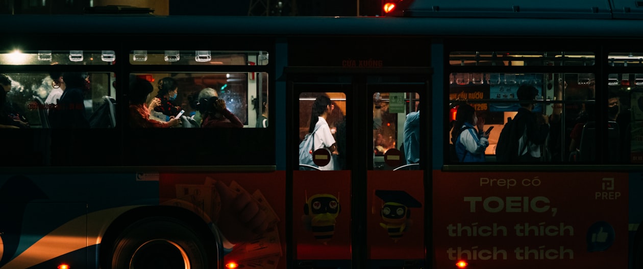 Busy illuminated street in Vietnam at night with motorbikes and pedestrians, representing the urban residential districts where tenant registration rules apply