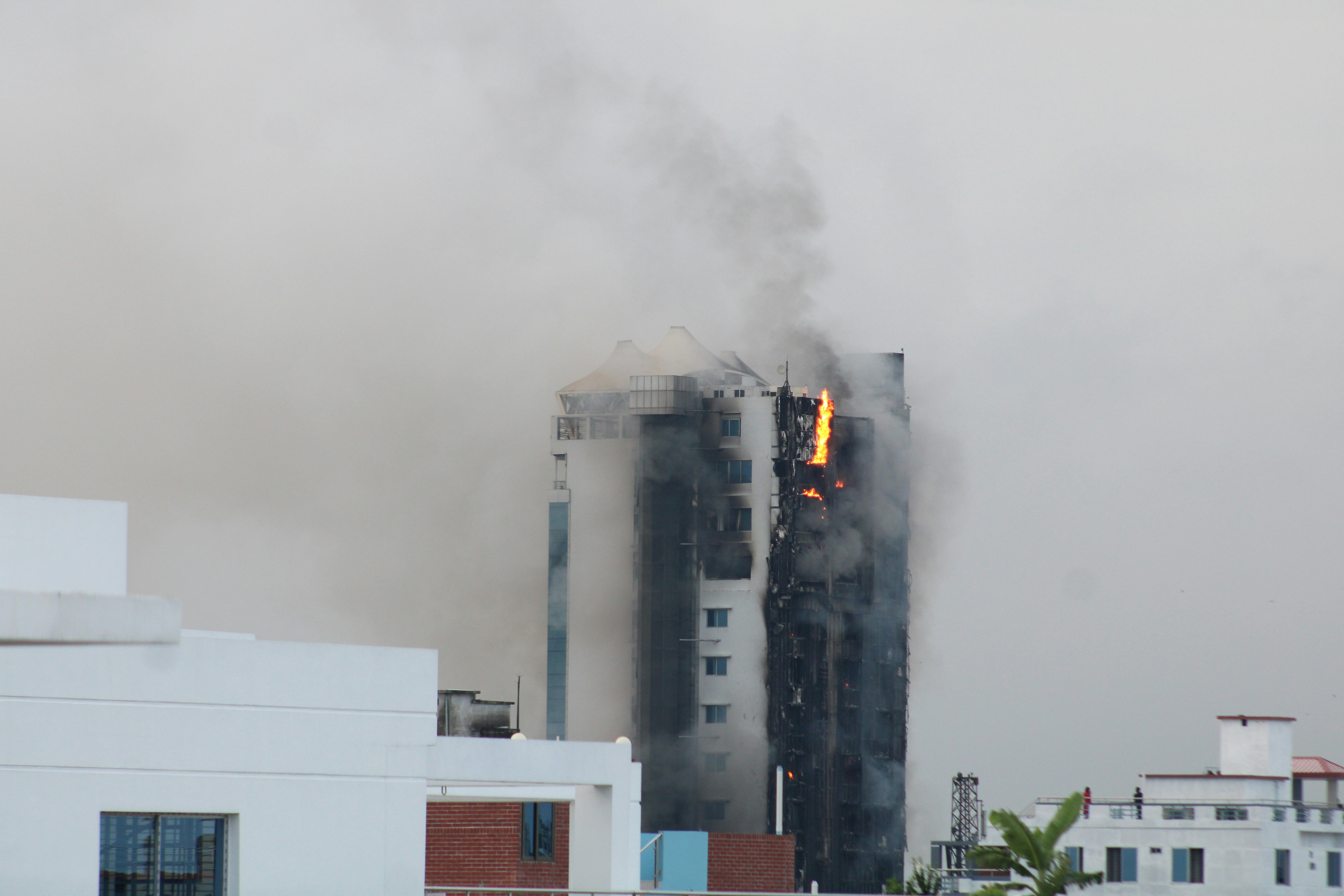 Smoke billows from the top of a building