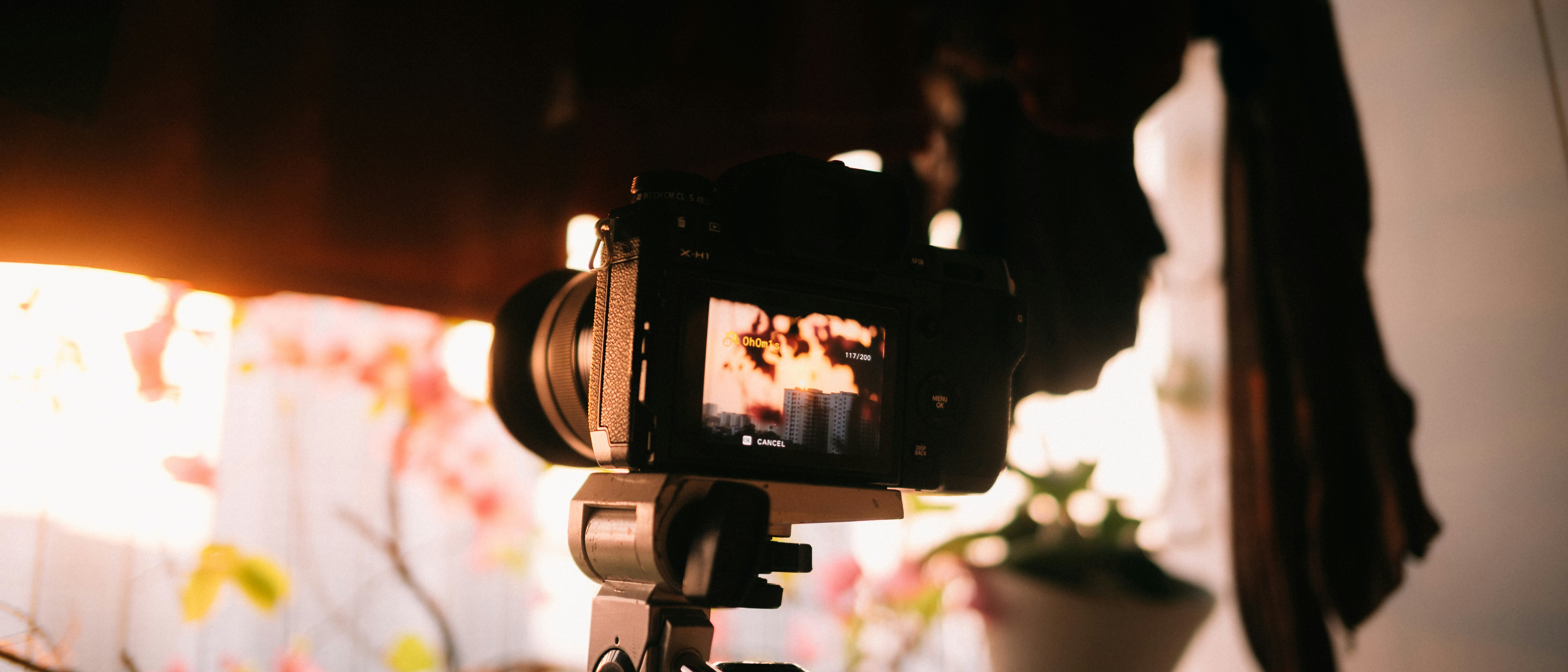 A camera set up on a tripod in a room