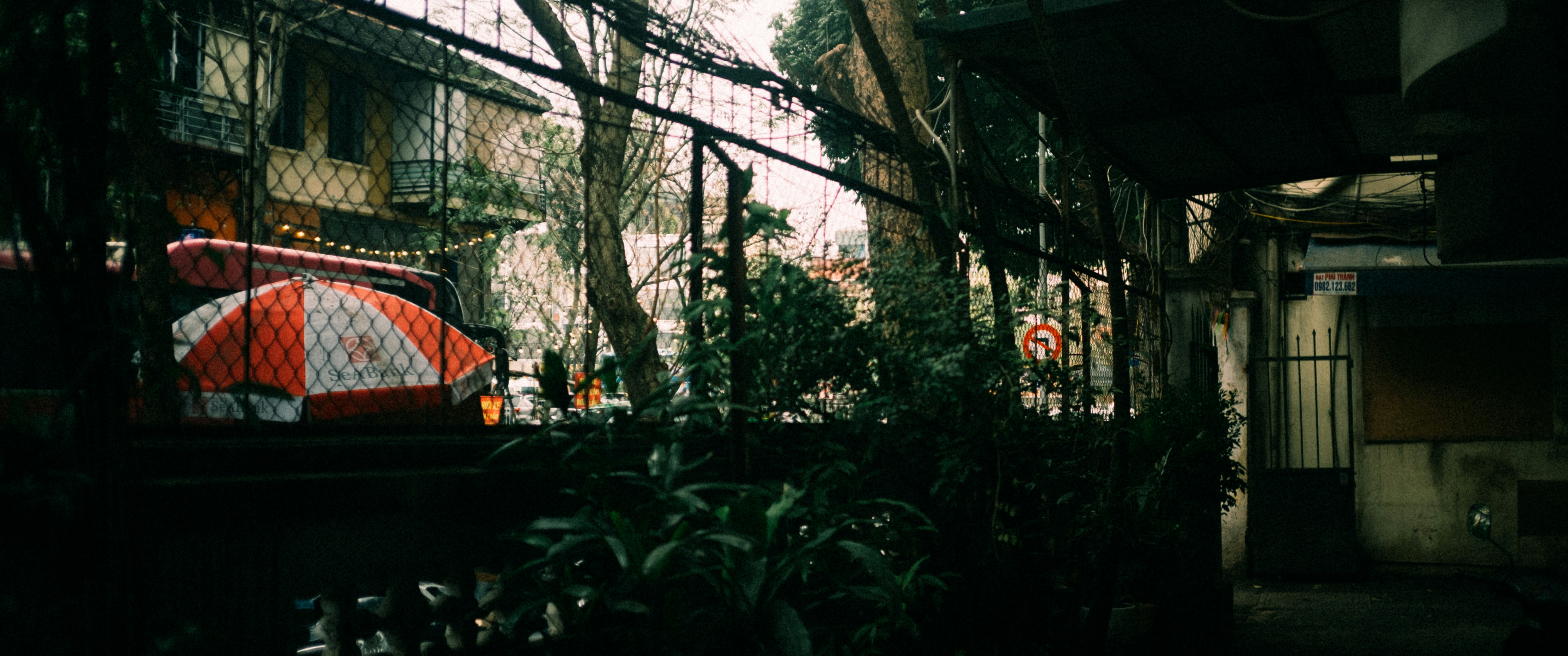 A red truck parked next to a tall building