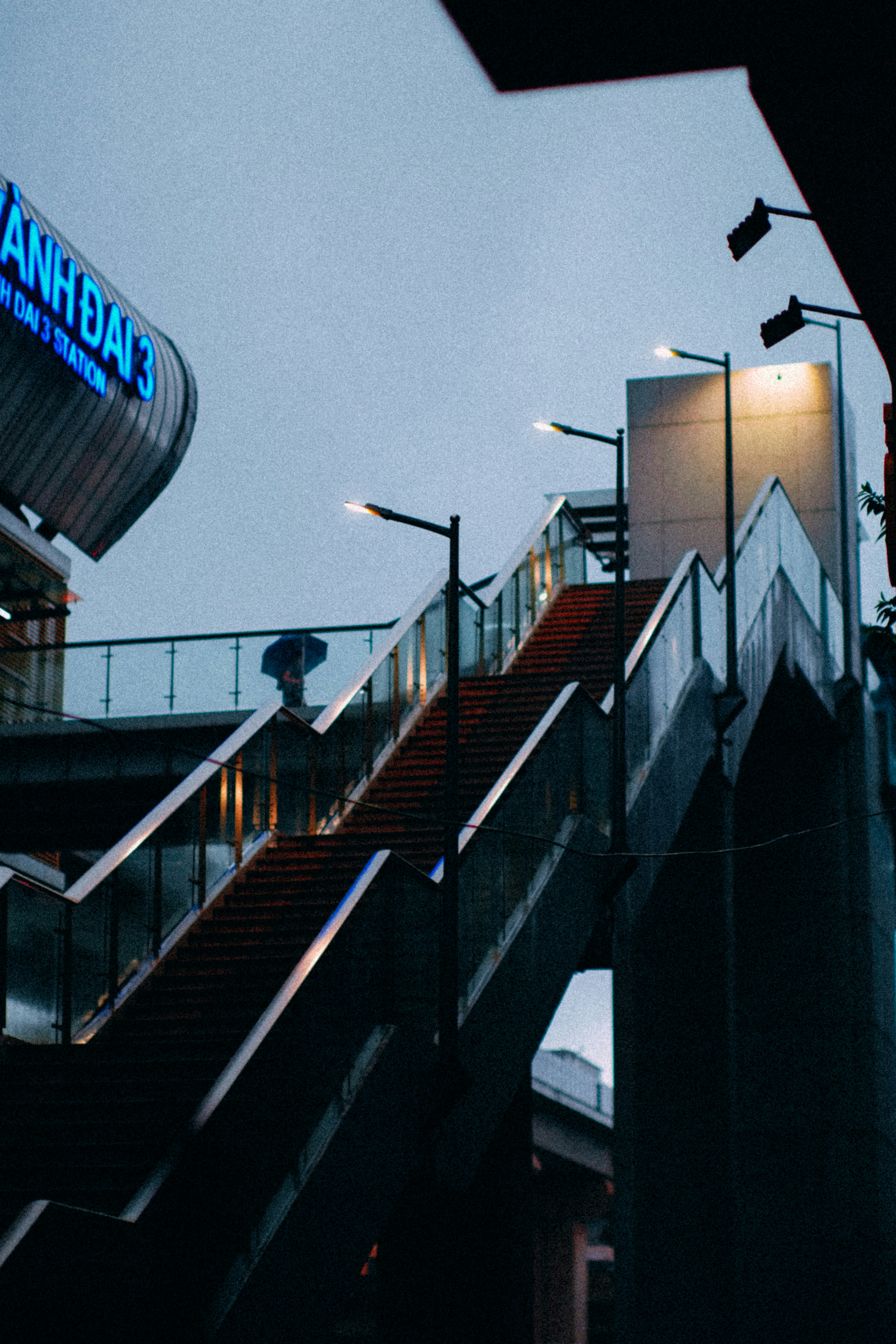 An escalator with a sign on it next to a building