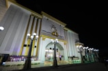 A large white building lit up at night