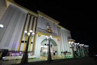 A large white building lit up at night