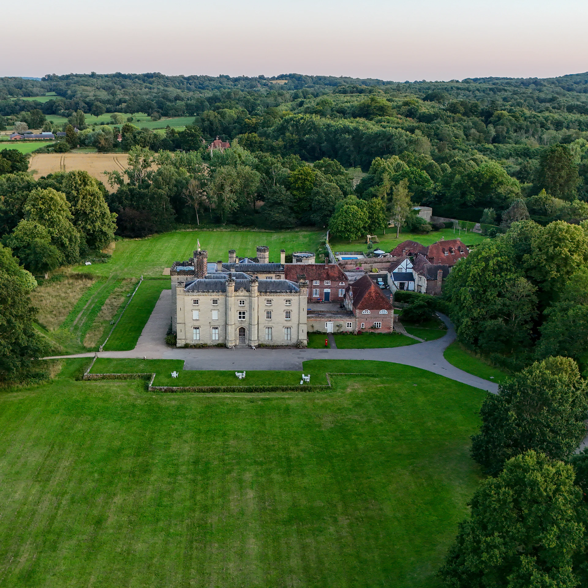 An aerial view of the stately house and its extensive formal grounds